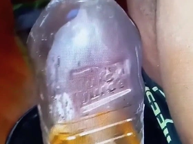 Pissing in a Large Juice Container